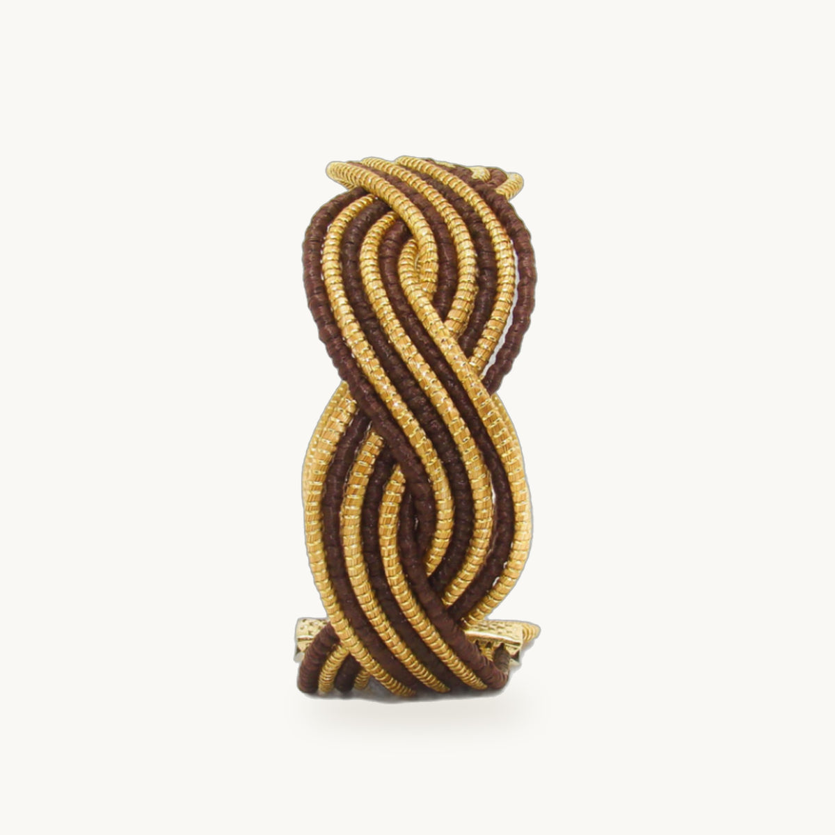 Manchette Caracol ORA alternée chocolat, capim dourado tressé main en nœud infini, fond beige