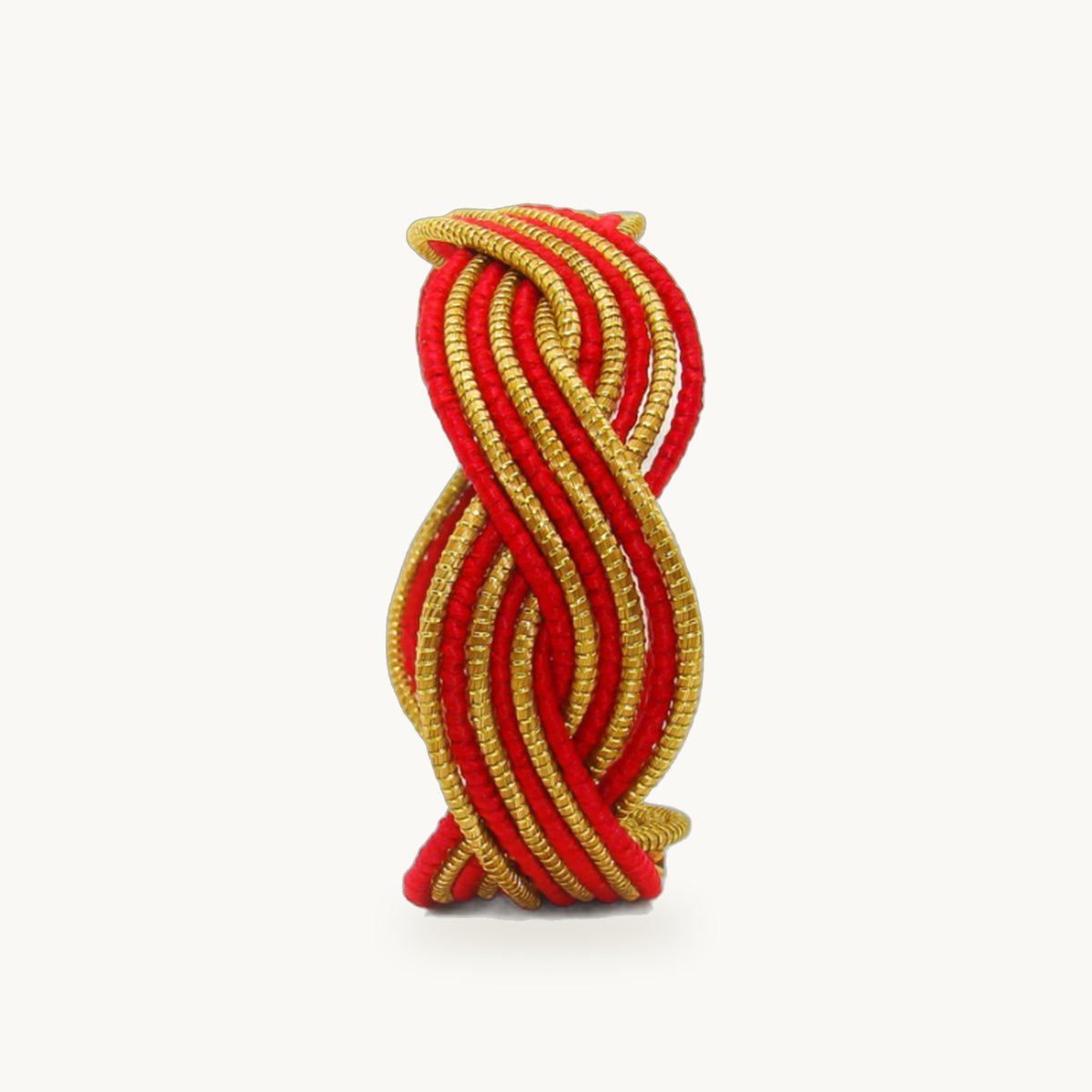 Manchette Caracol ORA alternée rouge, capim dourado tressé main en nœud infini, fond beige