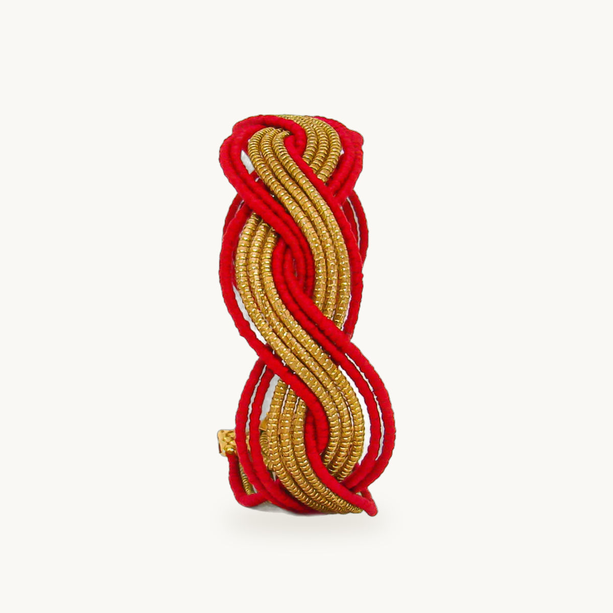 Manchette Caracol ORA bayadère rouge, capim dourado tressé main en nœud infini, fond beige
