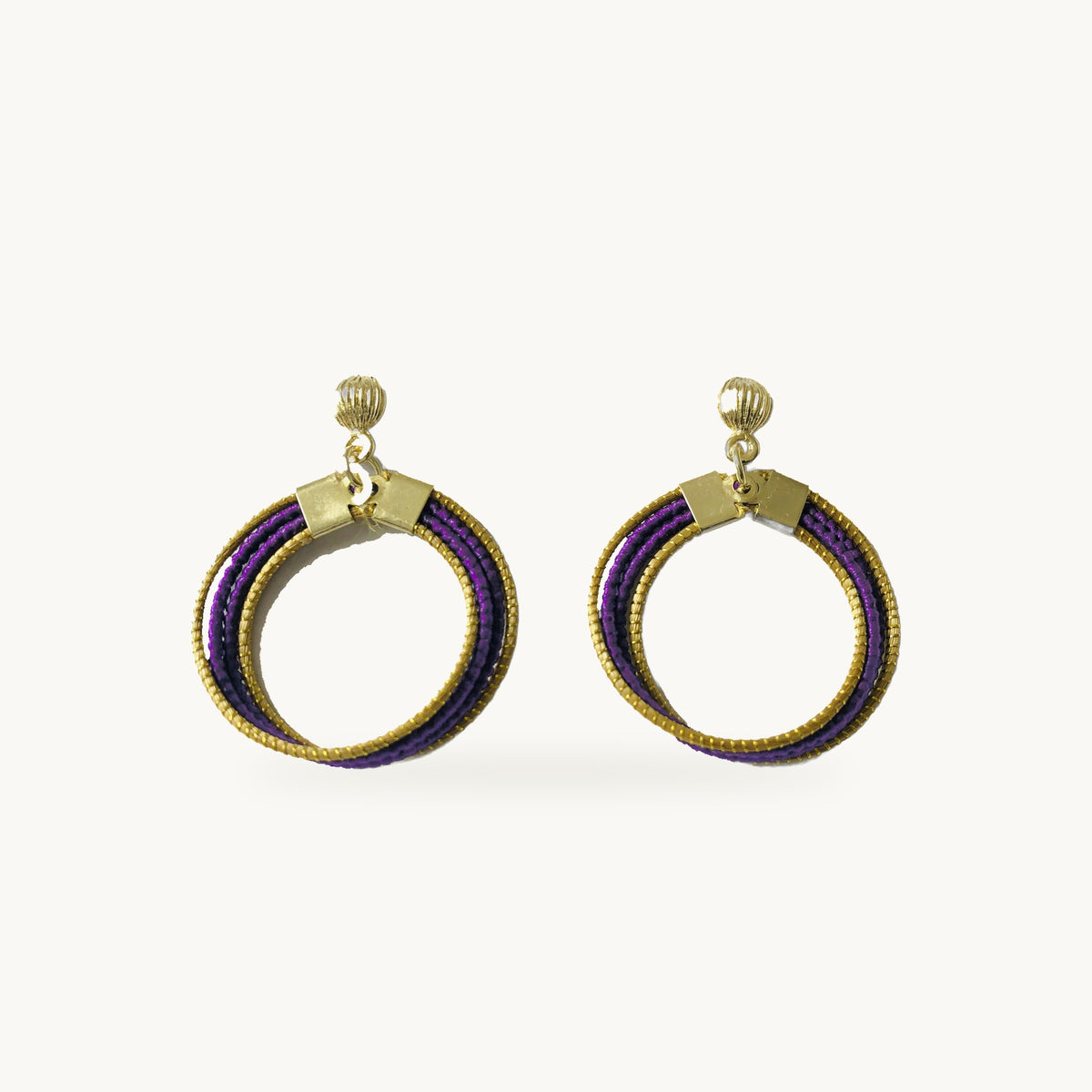 Boucles d'oreilles Lola Arco-Íris ORA violettes, capim dourado tressé main, fond beige